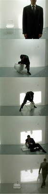A Chair, a suit and rubber bands manipulated to make a video - 'Calf Roping' (2003)