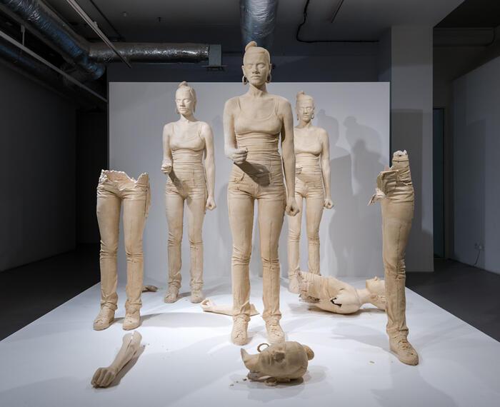 five terracotta-dyed, life-size, cast plaster female figures and video